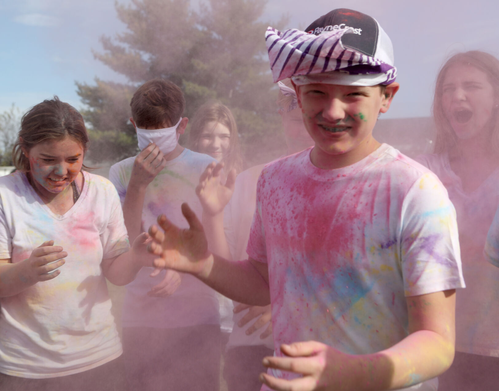 Students emerge from a pink cloud
